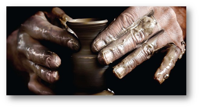Hands forming a clay jar