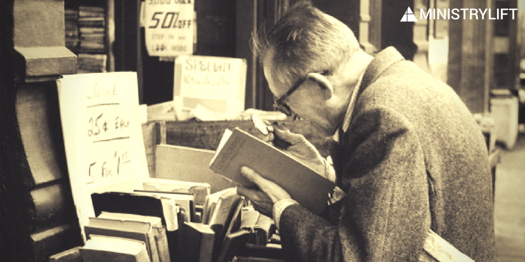 men reading with magnifying glass
